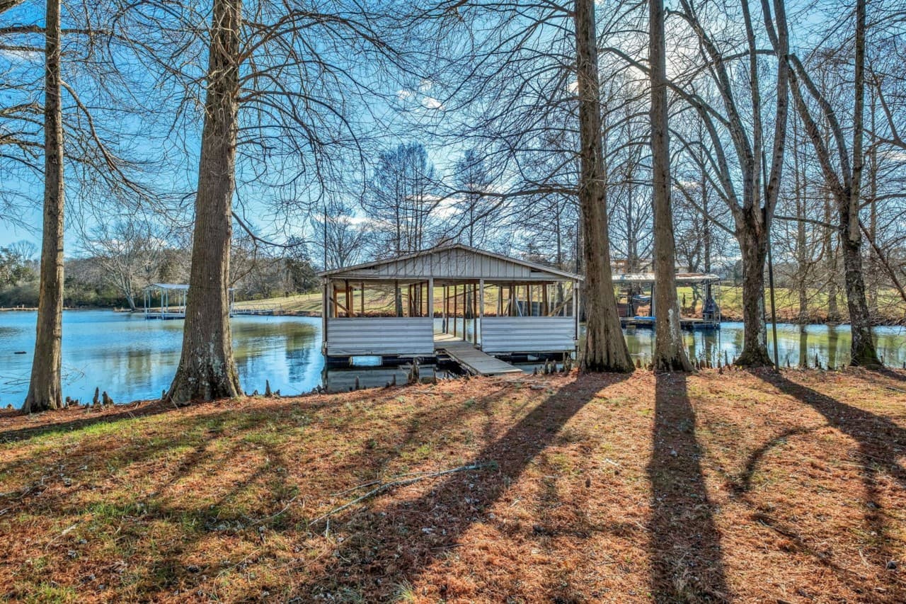 The private dock beyond the tree-lined shoreline at 550 Drifting Circle West